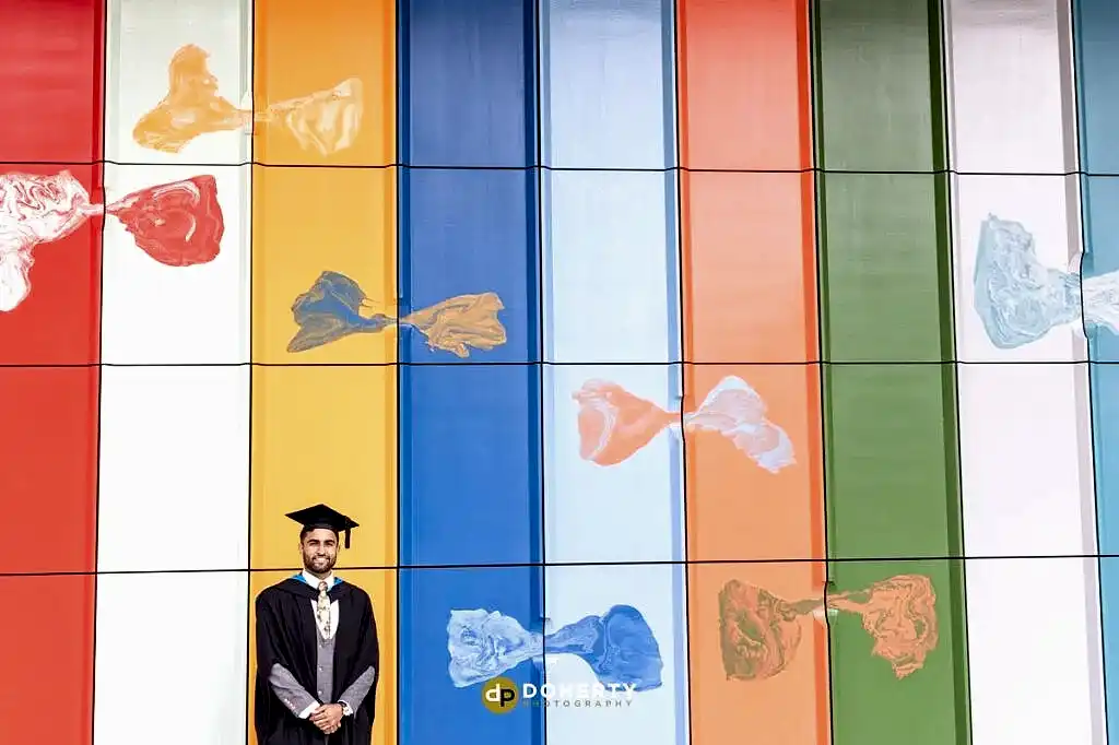 Graduation portraits of man with coloured backdrop