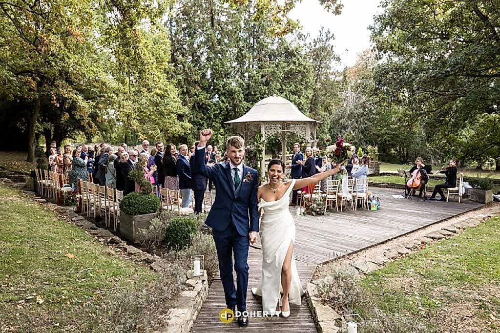 Bride and groom celebrate at Eastington Park - Wedding Photographer - Cotswolds